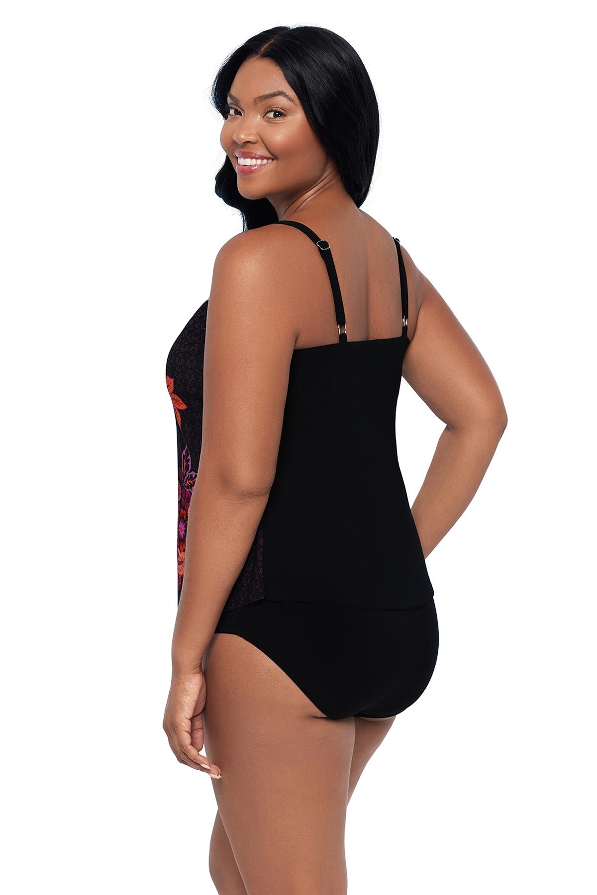 Woman turned left wearing a pink and orange floral printed tankini top 