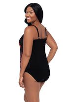 Woman turned left wearing a pink and orange floral printed tankini top 