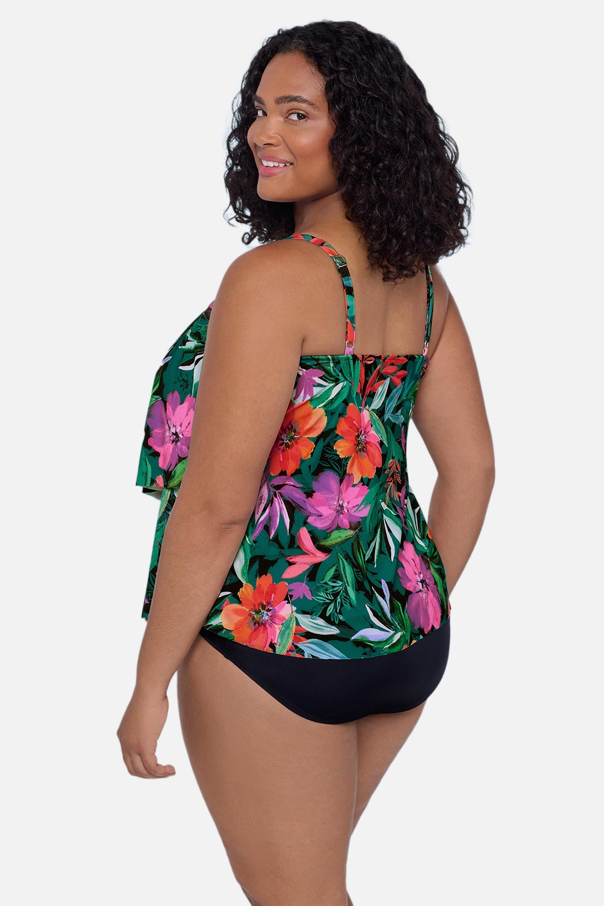 Woman turned left wearing a multicolor floral and leaf printed tankini top