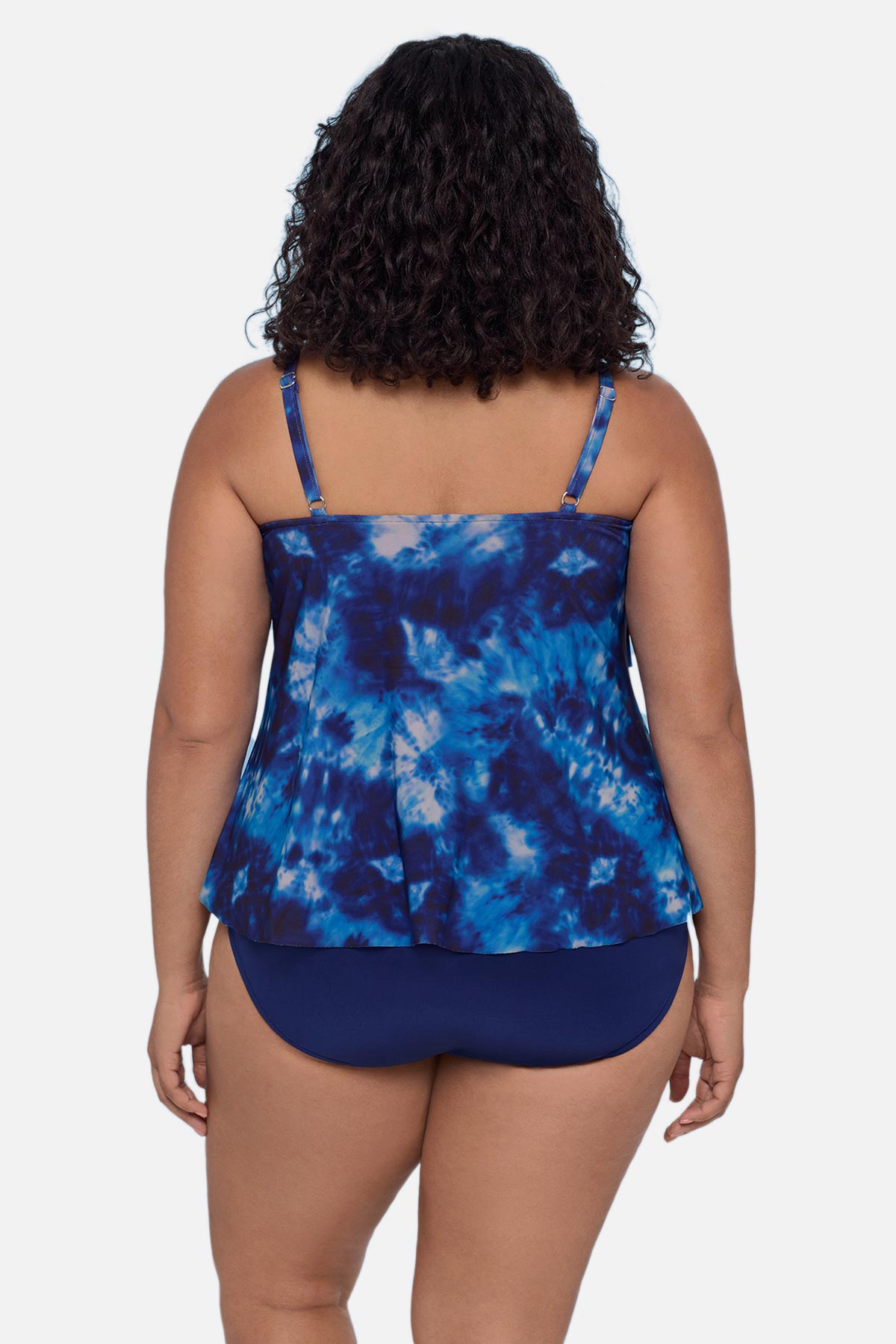 Woman turned away wearing a blue tie dye tankini top