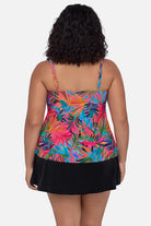Woman turned away wearing a multicolored palm leaf printed tankini top