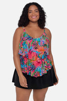 Woman wearing a multicolored palm leaf printed tankini top with ruffles