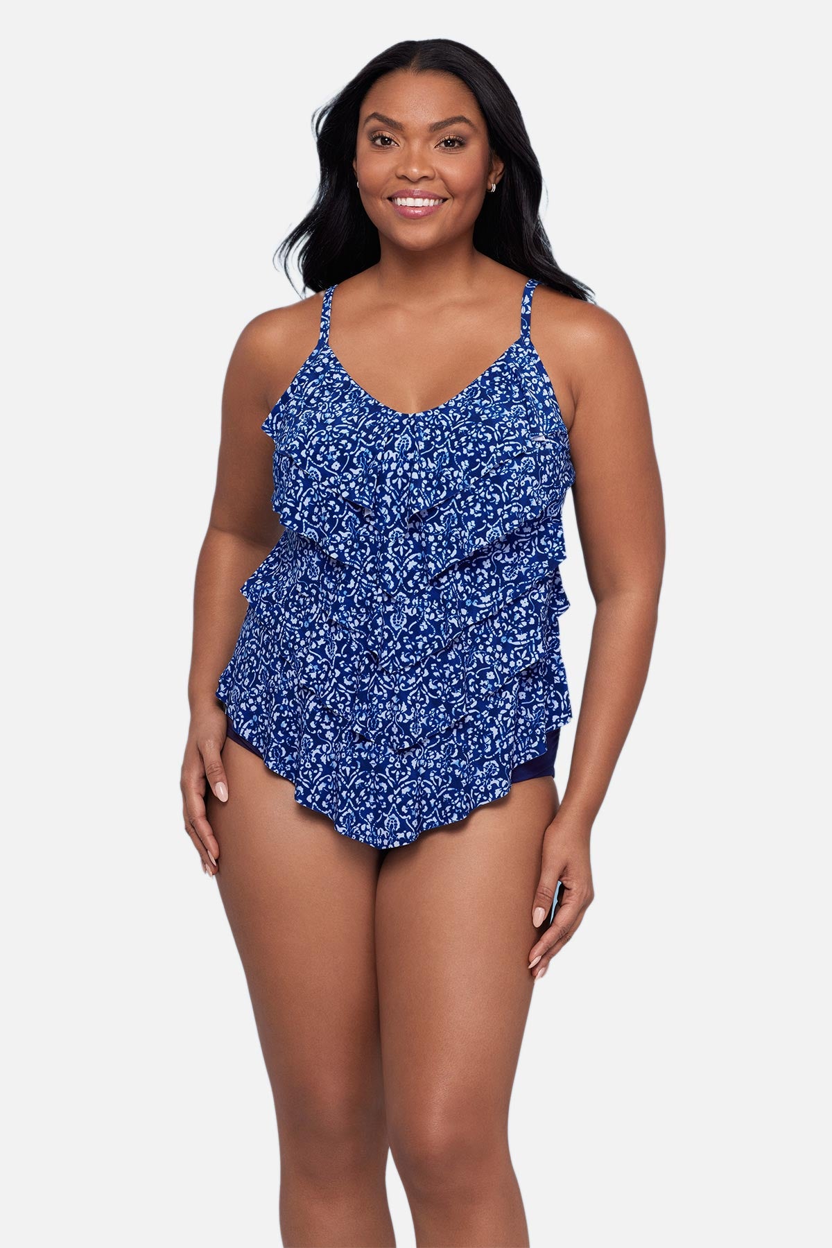 Woman wearing a blue scroll printed tankini top with ruffles