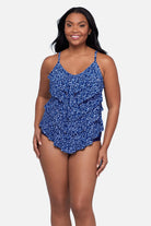 Woman wearing a blue scroll printed tankini top with ruffles