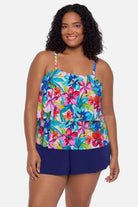 Woman wearing a multicolored floral printed swim romper with ruffles