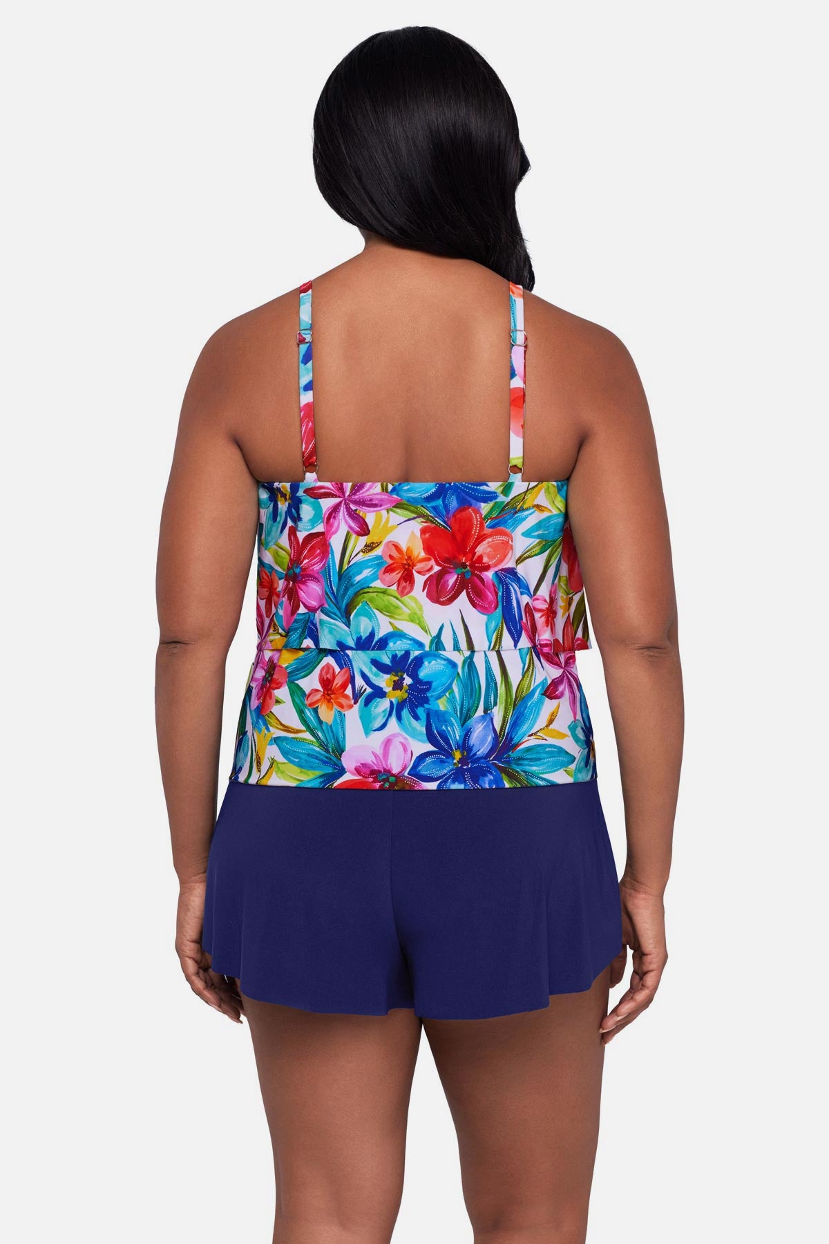 Woman turned away wearing a multicolored floral printed swim romper with ruffles