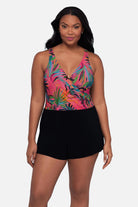 Woman wearing a multicolored palm leaf printed swim romper