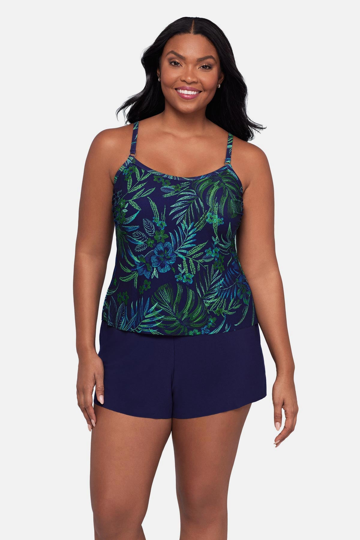 Woman wearing a blue and green jungle printed swim romper