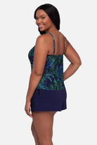 Woman turned left wearing a blue and green jungle printed swim romper
