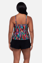 Woman turned away wearing an abstract multicolored printed swim romper