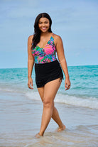 Woman on beach wearing a multicolored palm leaf printed swim dress