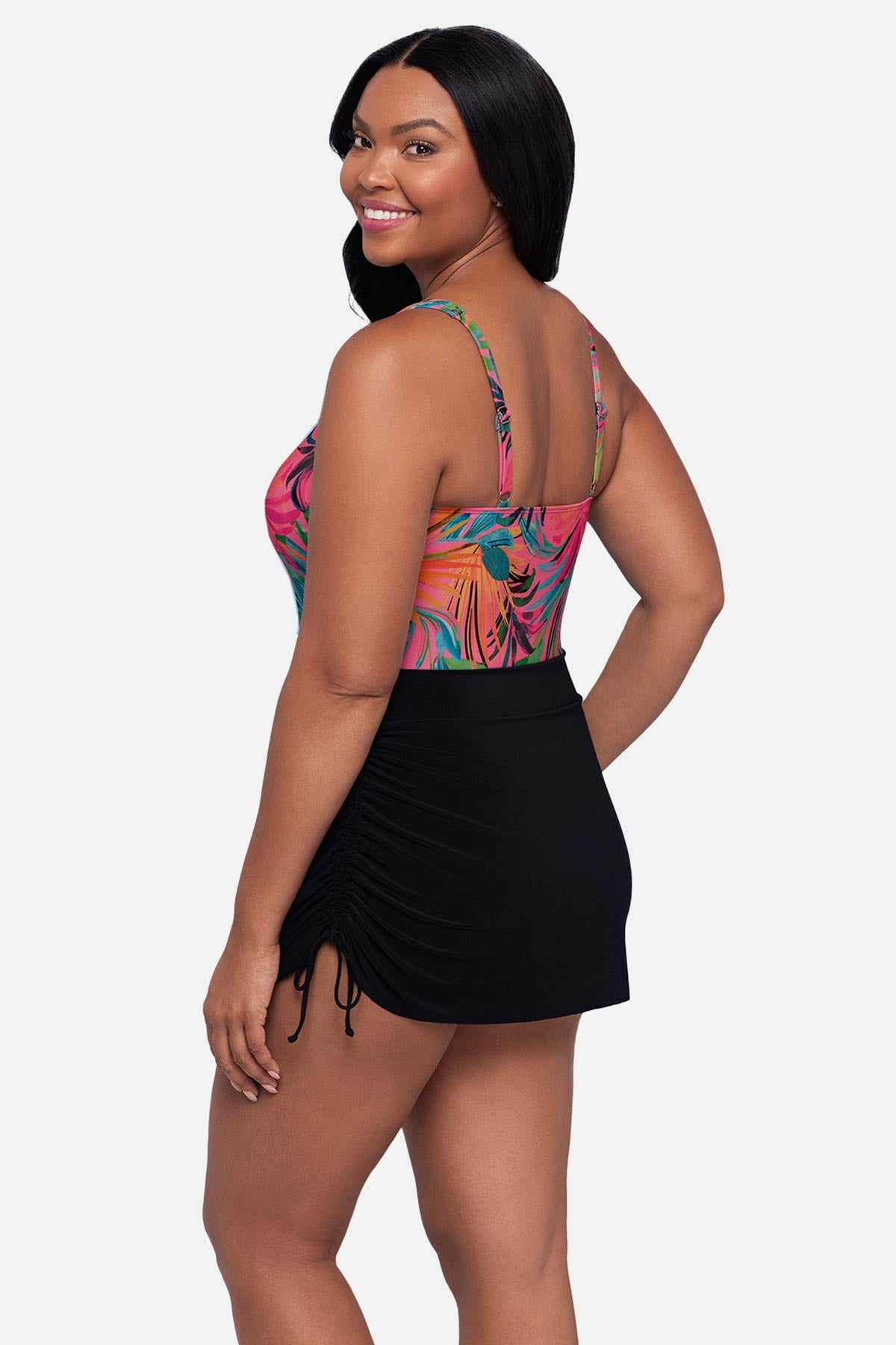 Woman turned left wearing a multicolored palm leaf printed swim dress