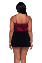 Woman turned away wearing a red and purple tile pattern swim dress