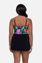 Woman turned away wearing a multicolor floral and leaf printed swim dress