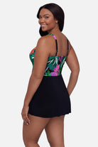 Woman turned left wearing a multicolor floral and leaf printed swim dress