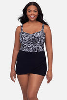 Woman wearing a black and white paisley printed swim dress