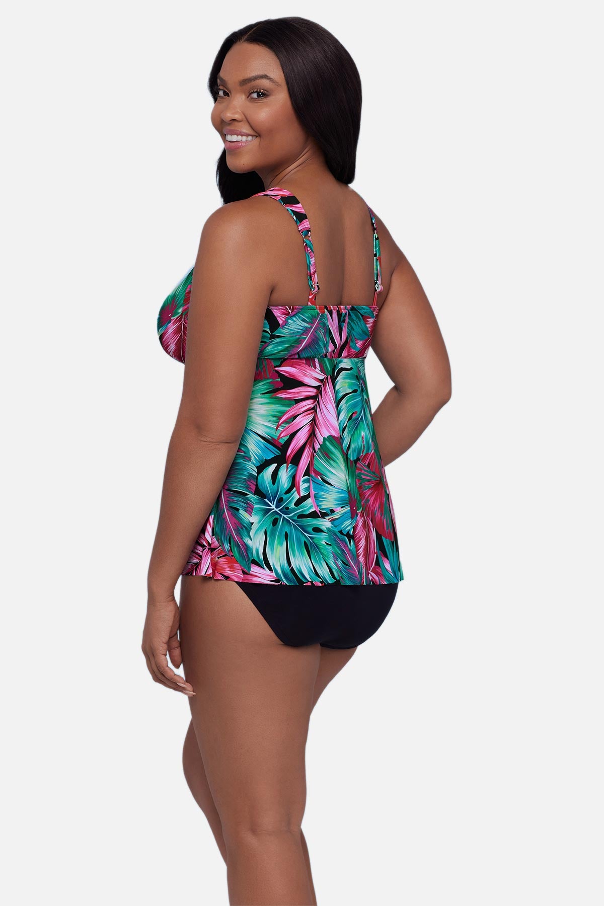 Woman turned left wearing a multicolor palm leaf printed tankini top