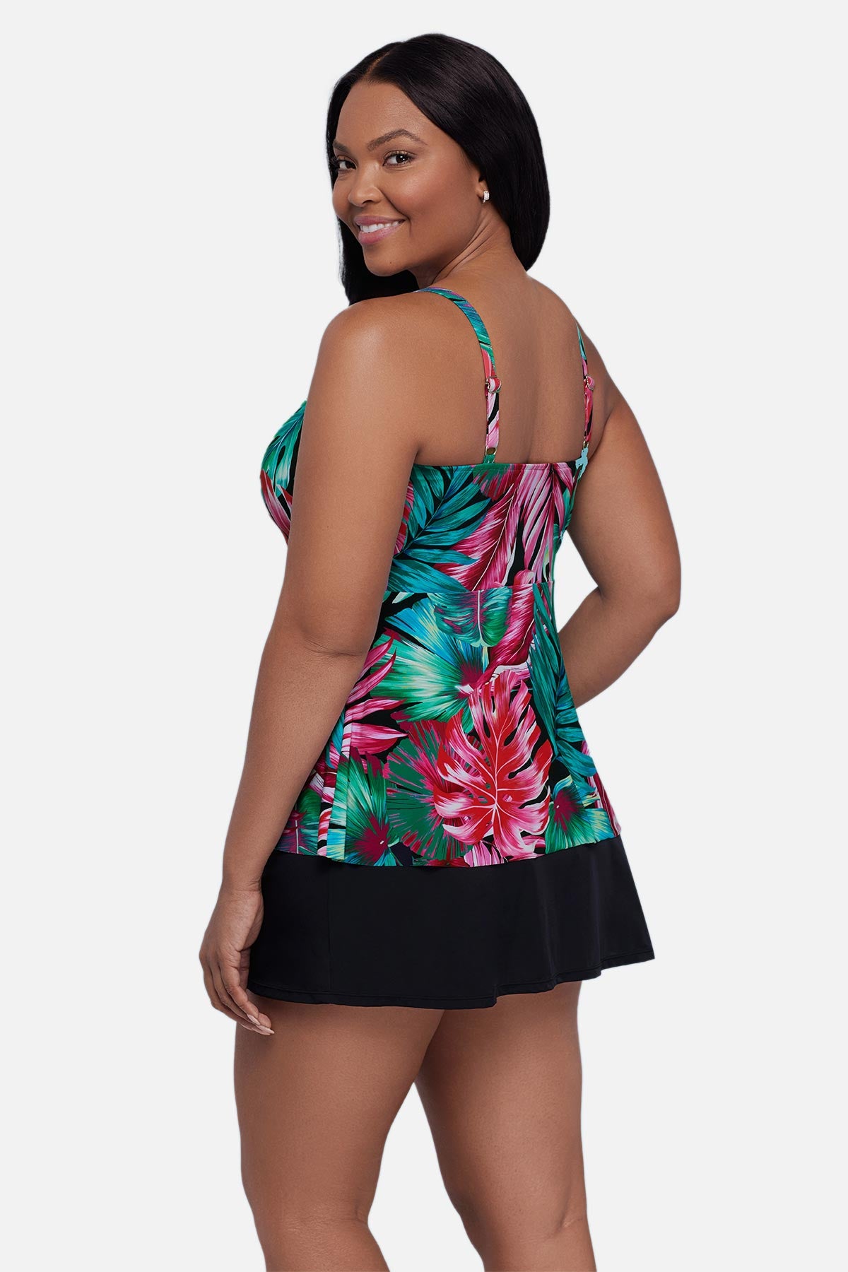 Woman turned left wearing a multicolor palm leaf printed tankini top
