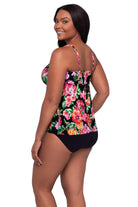 Woman turned left wearing a pink floral print tankini top