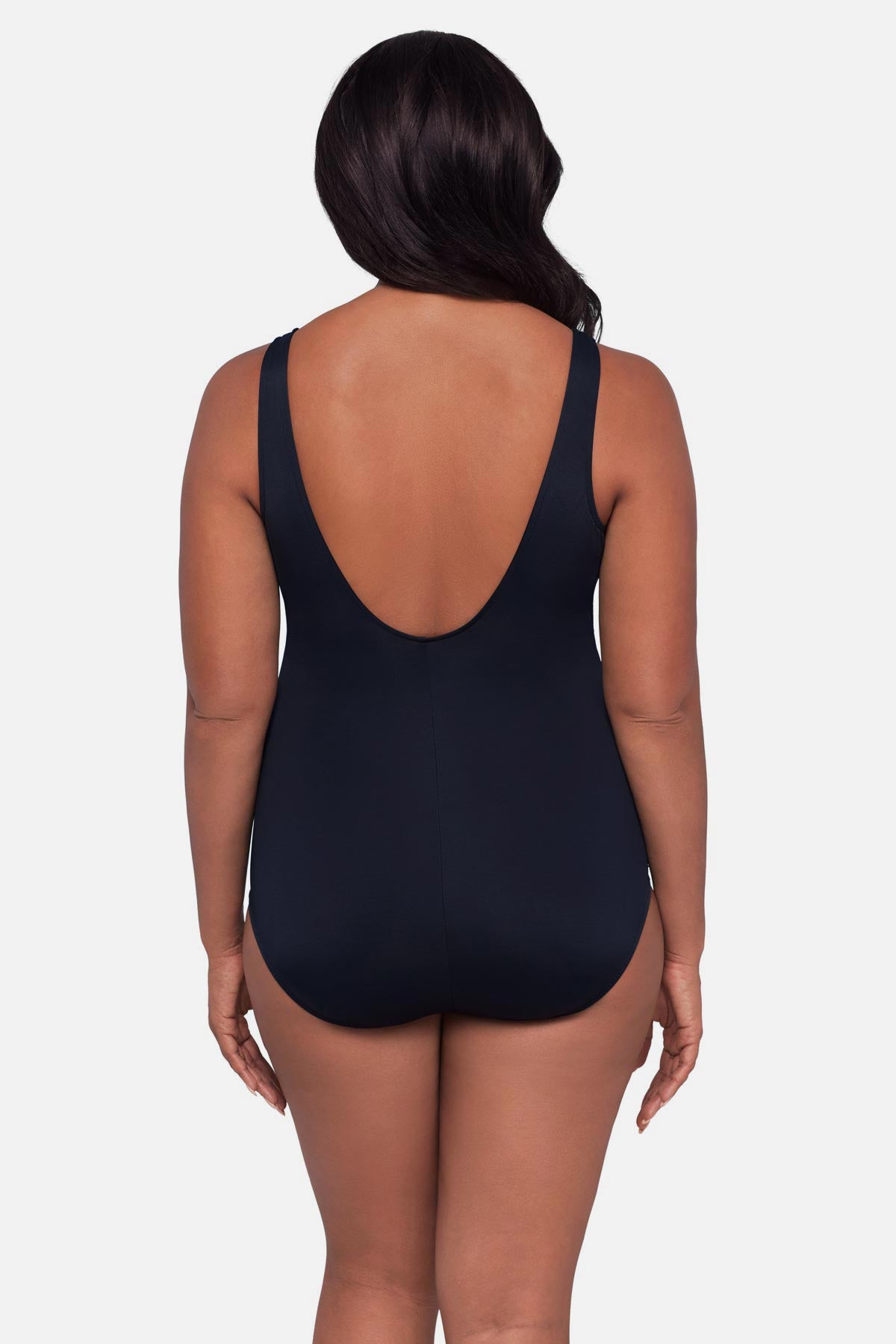 Woman turned away wearing a multicolored floral printed one-piece swimsuit