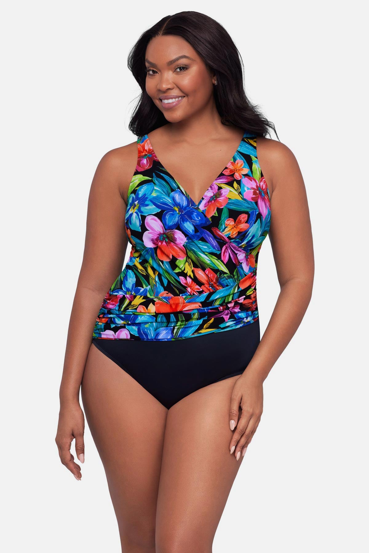 Woman wearing a multicolored floral printed one-piece swimsuit