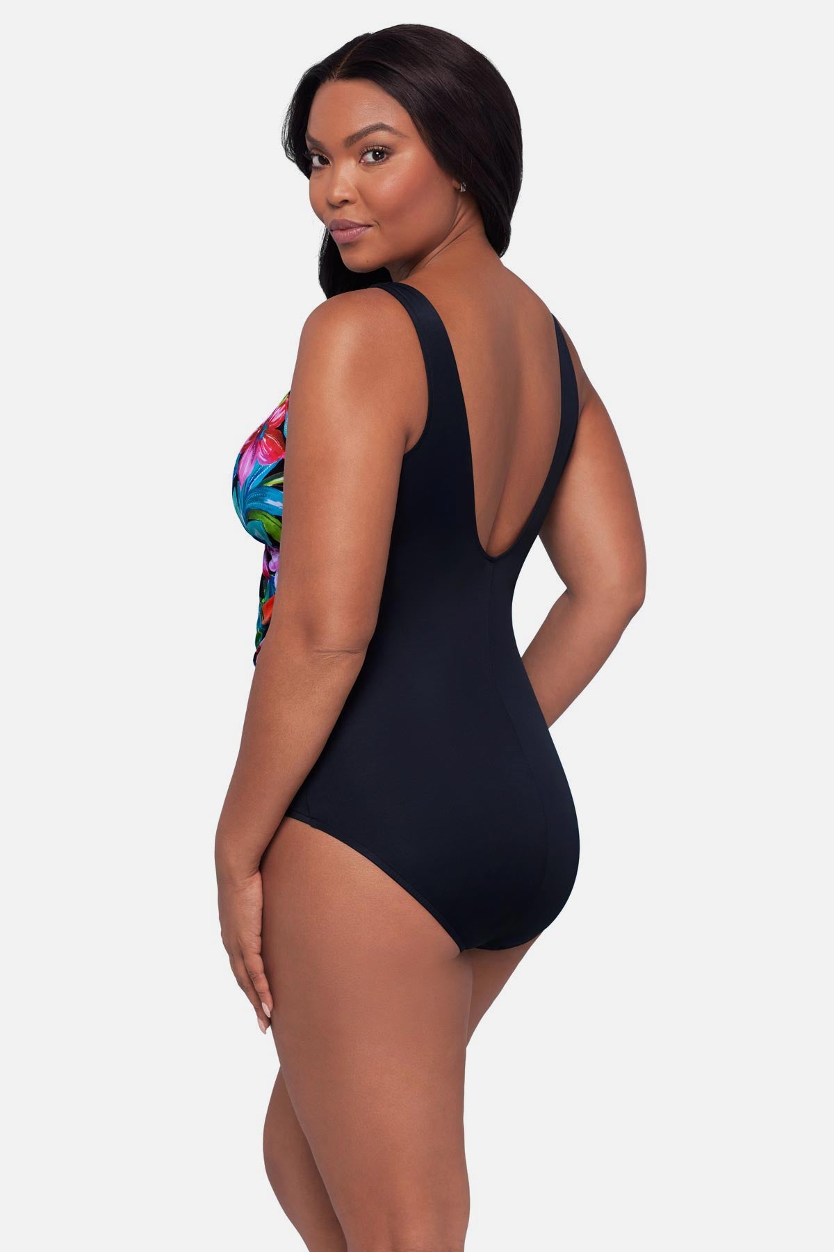 Woman turned left wearing a multicolored floral printed one-piece swimsuit