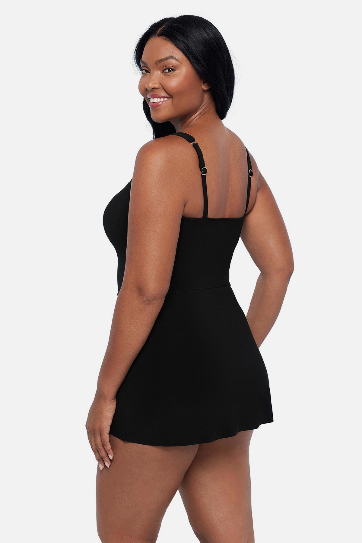 Woman turned left wearing a black swim dress with a sweetheart neckline