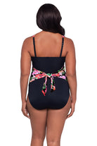 Woman turned away wearing a pink floral printed one-piece swimsuit