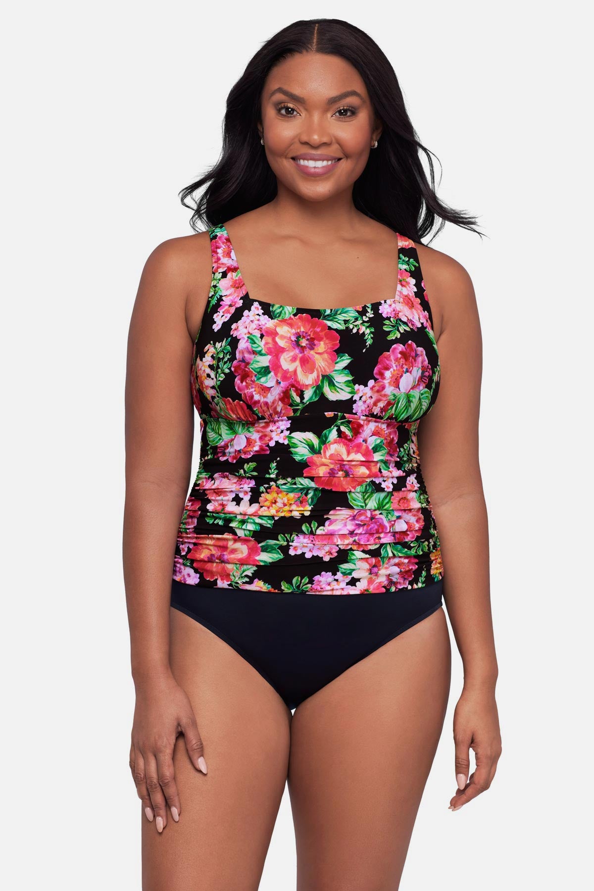 Woman wearing a pink floral printed one-piece swimsuit