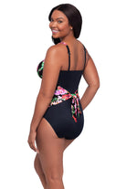 Woman turned left wearing a pink floral printed one-piece swimsuit