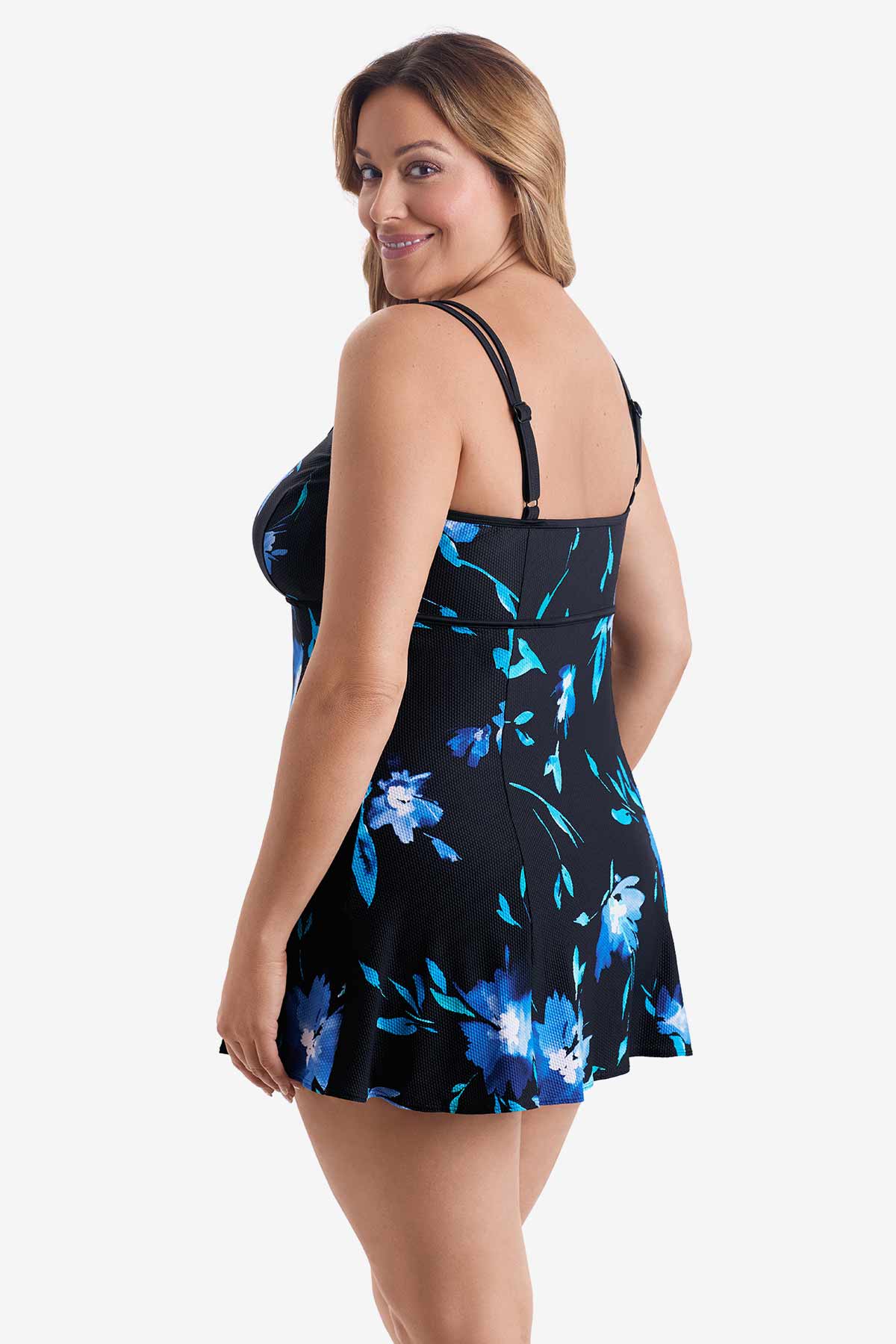 Woman turned left wearing a blue floral printed swim dress