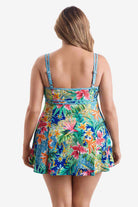 Woman turned away wearing a multicolored swim dress with a palm leaf pattern