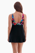 Woman turned away wearing a swim dress with a multicolored print on the back