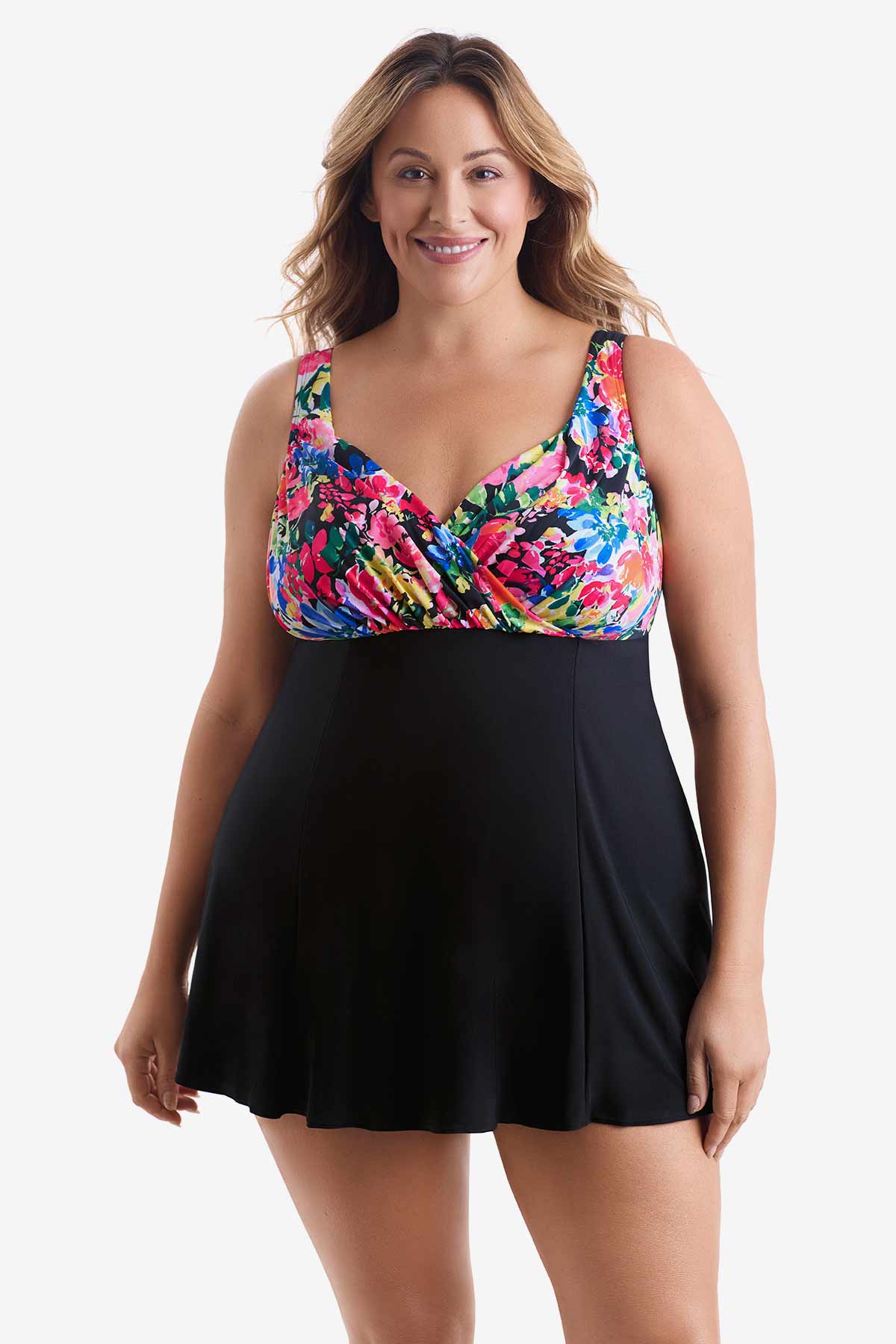 Woman wearing a swim dress with a multicolored print on the bust