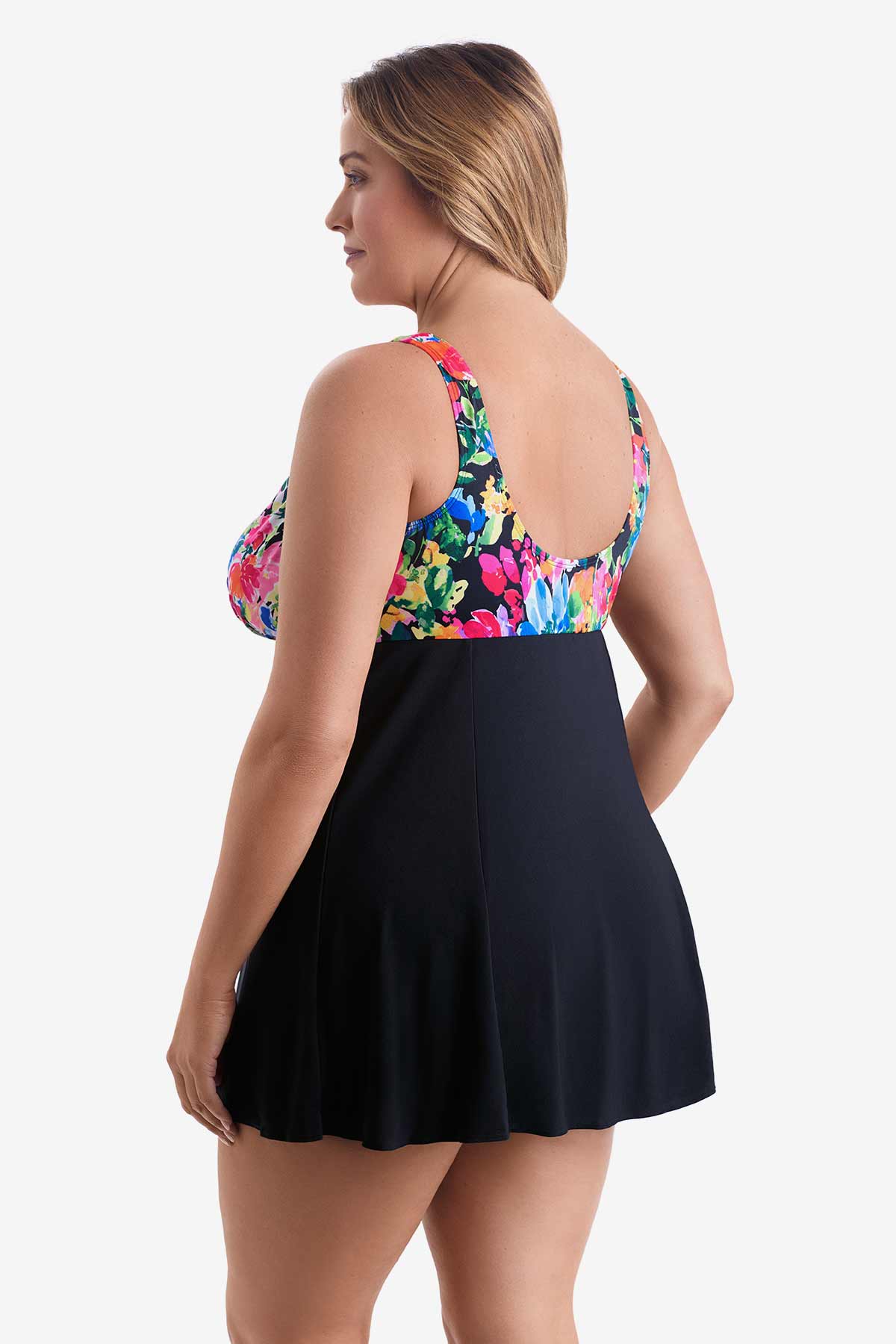 Woman turned left wearing a swim dress with a multicolored print on the bust
