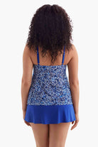 Woman turned away wearing a one-piece swimsuit with a blue and white pattern