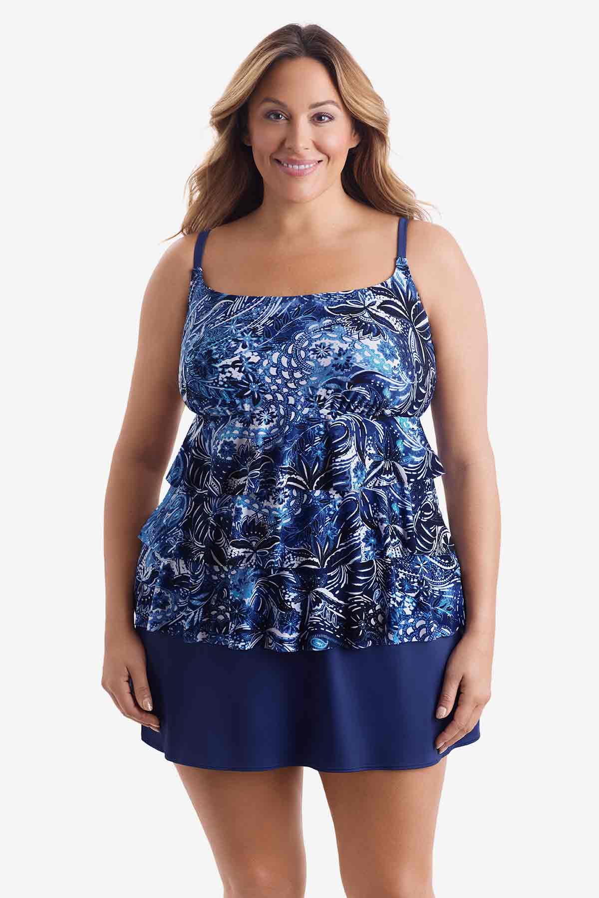 Woman wearing a tiered one-piece swimsuit with an abstract blue pattern