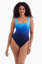 Woman wearing a blue ombre one-piece swimsuit