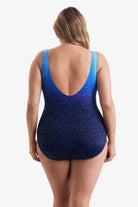 Woman faced away wearing a one-piece swimsuit with a blue ombre pattern