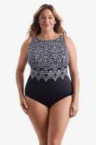 Woman wearing a one-piece swimsuit with an abstract black and white pattern
