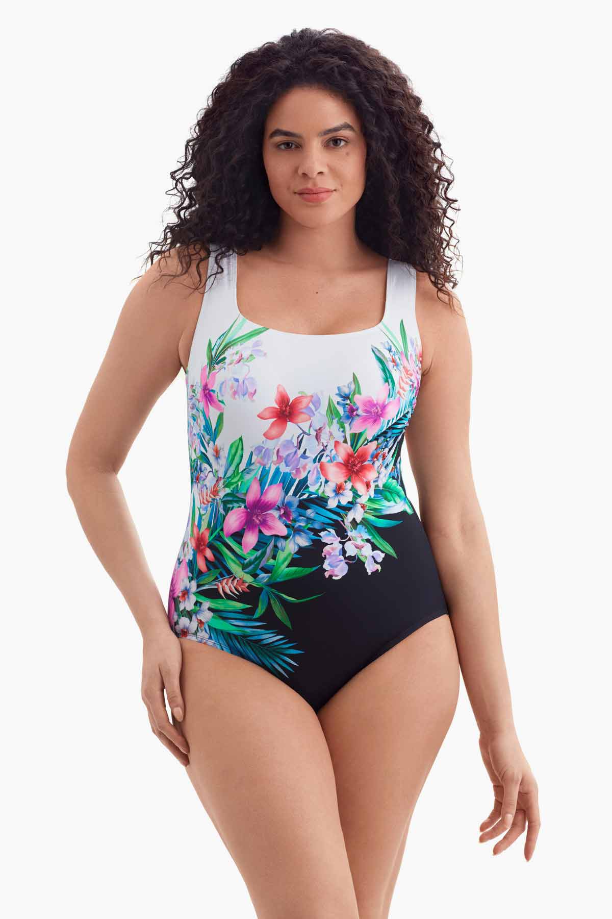 Woman wearing a scoop neck one-piece swimsuit with florals across the body