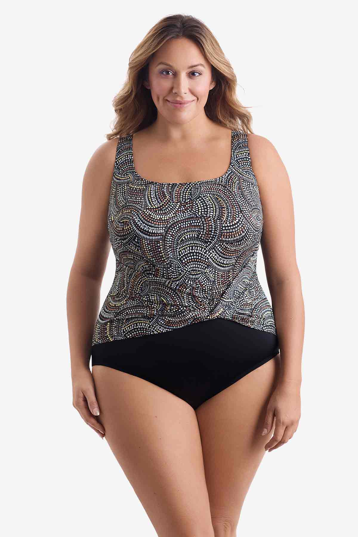 Woman wearing a one-piece swimsuit with a multicolored dot pattern