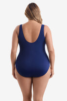 Woman faced away wearing a blue one-piece swimsuit 