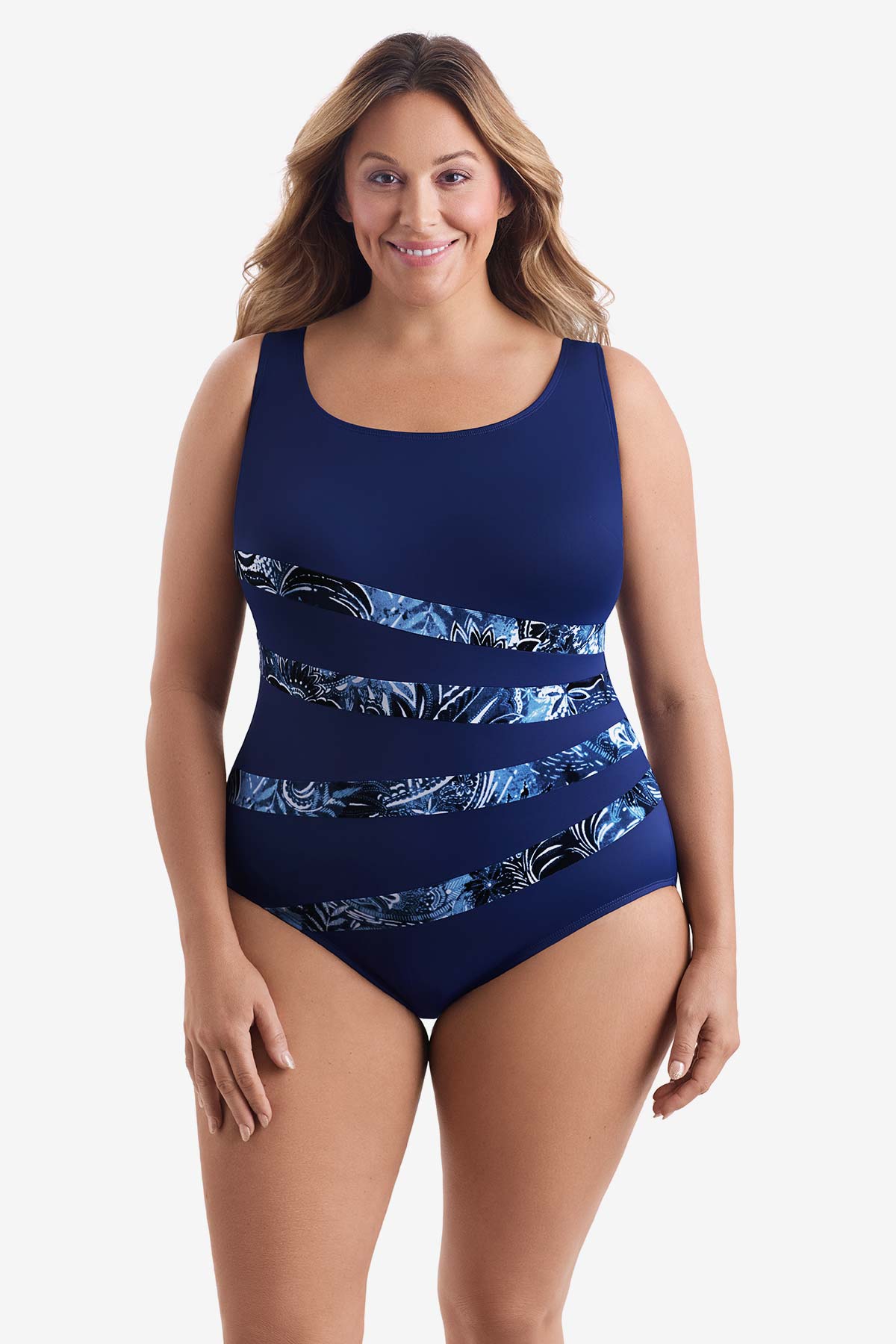 Woman wearing a blue one-piece swimsuit with four streaks of an abstract print across the suit