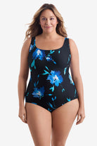Woman wearing a large blue floral printed one-piece swimsuit