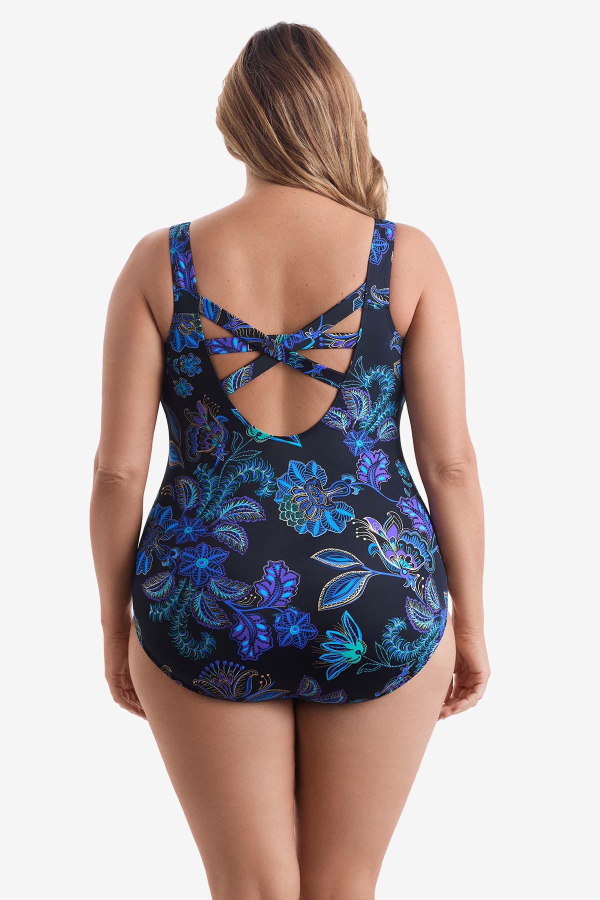 Woman faced away wearing a blue flower printed one-piece swimsuit with and X back