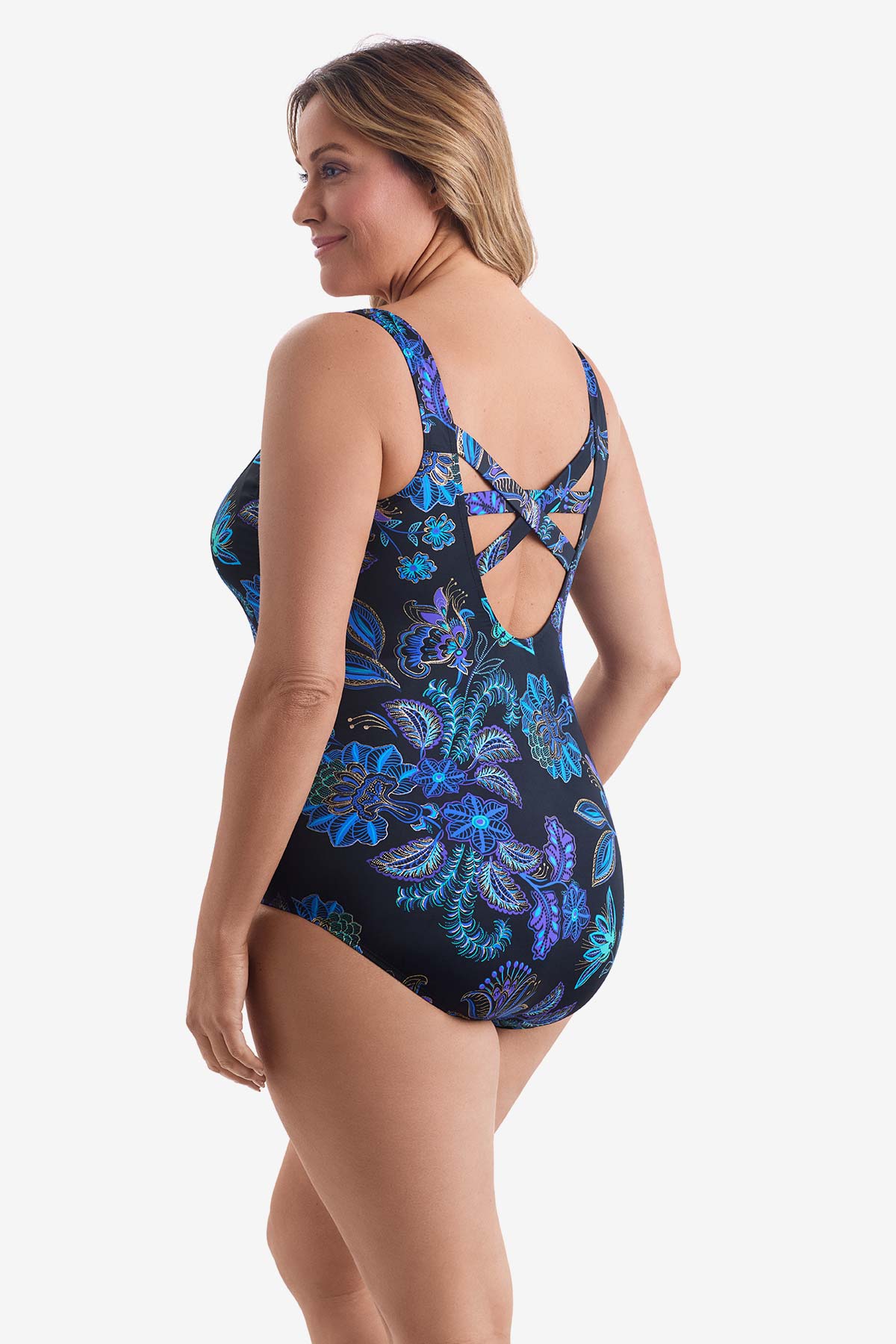 Woman faced left wearing a blue flower printed one-piece swimsuit