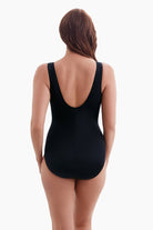 Woman faced away wearing a one-piece swimsuit