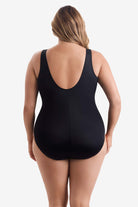 Woman faced away wearing a black one-piece swimsuit
