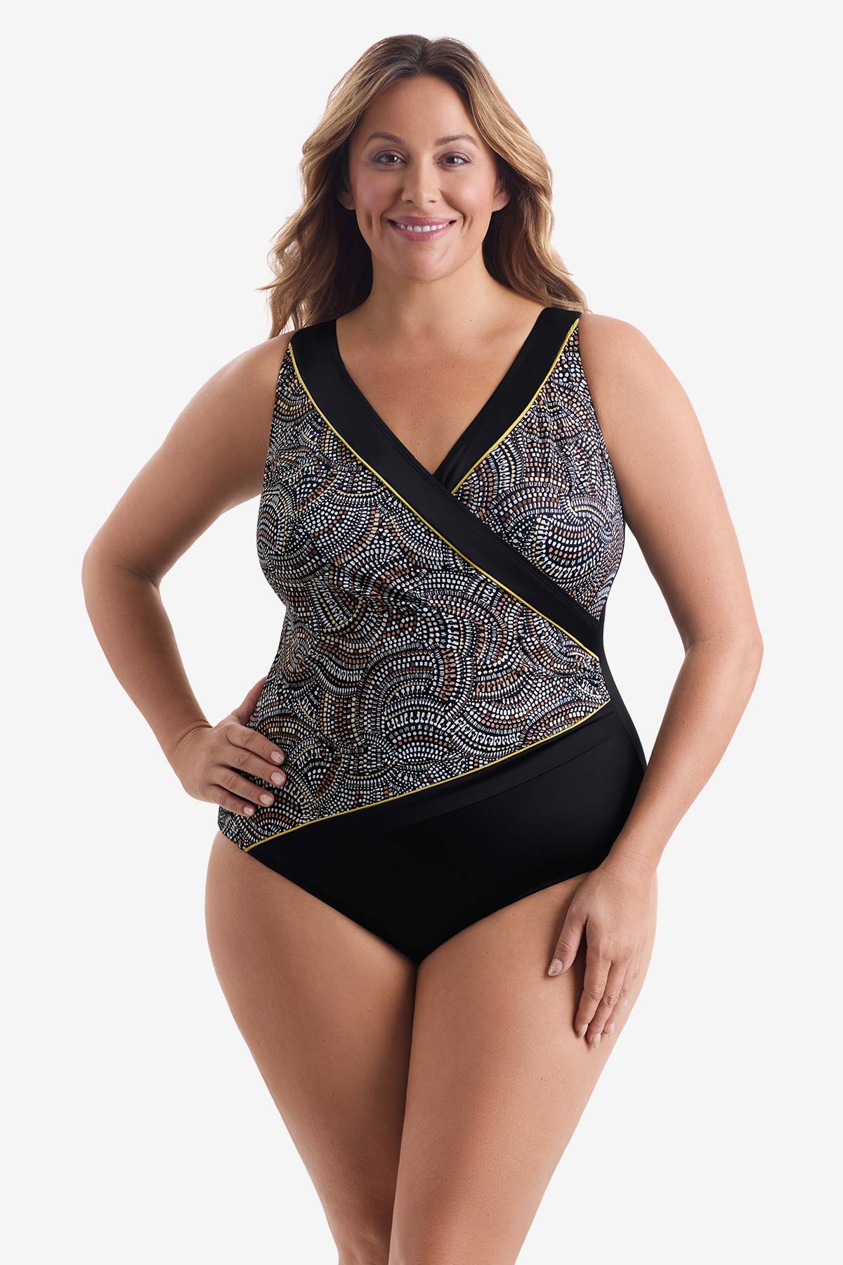 Woman wearing a black, white & gold dot pattern one-piece swimsuit
